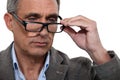 Man with lowered glasses Royalty Free Stock Photo