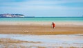 Man at low tide Sandwich Bay beach Kent England