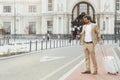 Man with luggage looking at mobile screen near station Royalty Free Stock Photo