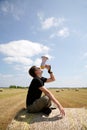 Man lying on bale of hay and yells in meg Royalty Free Stock Photo