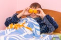Man lying in bed and funny tangerines Royalty Free Stock Photo