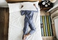 Man lying on bed with insomnia