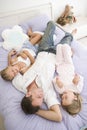 Man lying in bed with two young girls smiling Royalty Free Stock Photo