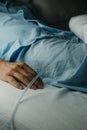 man lying in bed wearing a urinary catheterization