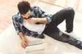 Man lying on carpet and using laptop Royalty Free Stock Photo