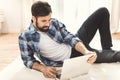 Man lying on carpet and using laptop Royalty Free Stock Photo