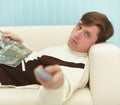 Man, lying on couch with magazine Royalty Free Stock Photo