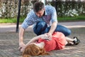 Man lying girl in recovery position Royalty Free Stock Photo