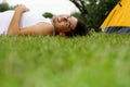 Man lying on grass near tent Royalty Free Stock Photo