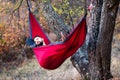 Man lying in a hammock and relaxing outdoors Royalty Free Stock Photo