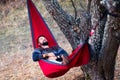 Man lying in a hammock and relaxing outdoors Royalty Free Stock Photo