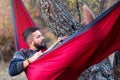 Man lying in a hammock and relaxing outdoors Royalty Free Stock Photo