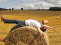 Man lying on hay bale Royalty Free Stock Photo