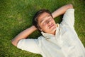 Man lying with his eyes closed and both hands behind his neck Royalty Free Stock Photo