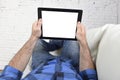 Man lying on home couch using digital tablet pad in portable internet technology Royalty Free Stock Photo