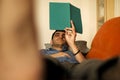 Man lying on the sofa concentrated reading notes