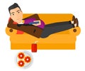 Man lying on sofa with junk food