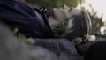 Man lying on stones with closed eyes with blurred forest leaves on the background. Stock. Man relaxing in nature. Royalty Free Stock Photo