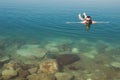 Man lying on water Dead Sea enjoying vacation .Tourism recreation, healthy lifestyle concept. Copy space Royalty Free Stock Photo