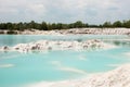 Man-made artificial clear blue lake Kaolin, mining ground holes covered by rain water.
