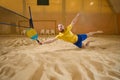 Man made jump and falls on sand while playing frescoball Royalty Free Stock Photo