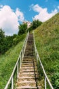 Man-made staircase upstairs to the hill with green grass, travel and tourism concept, vertical