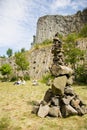 Man made stone tower outdoor, with unique basalt rock formation wall background.
