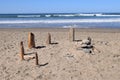 Man made structure from driftwood and rocks stuck on the beach Royalty Free Stock Photo