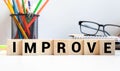 Man made word IMPROVE with wood blocks Royalty Free Stock Photo