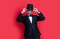 man magician wear tuxedo having fun in studio. magician man wearing cylinder hat. man magician Royalty Free Stock Photo