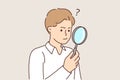 Man with magnifying glass works as private detective and tries to find small clues with loupe