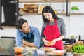 Man makes eye contact with woman in kitchen