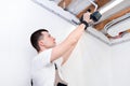 Man makes home repairs. Preparing to install a stretch ceiling Royalty Free Stock Photo
