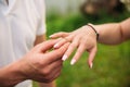 Man makes a marrige proposal to a girl. Gives her a ring for the engagement. Close-up hands Royalty Free Stock Photo