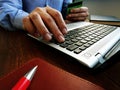 Man makes online purchase uses laptop and credit card for buying in internet Royalty Free Stock Photo