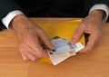 Man makes payment in Euros - with envelope Royalty Free Stock Photo