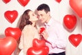 Man makes present to his lovely sweetheart girl. Lover`s valentine day. Valentine Couple. Man gives to his girlfriend sweets Royalty Free Stock Photo