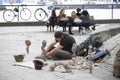 Man makes sculptures of stones on the waterfront