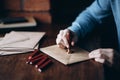 Man makes the stamp using sealing wax on the envelope