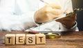 Man makes a test and writes results to a clipboard. Quality control, organization process management. Medical testing for