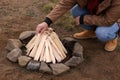 Man making bonfire outdoors, closeup. Camping season