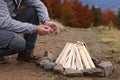 Man making bonfire outdoors, closeup. Camping season