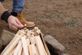 Man making bonfire outdoors, closeup. Camping season