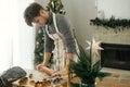 Man making christmas gingerbread cookies. Hands kneading gingerbread dough with rolling pin, golden cutters, cooking spices, Royalty Free Stock Photo