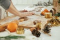 Man making christmas gingerbread cookies in modern white kitchen close up. Hands kneading gingerbread dough with rolling pin, Royalty Free Stock Photo