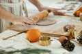 Man making christmas gingerbread cookies in modern white kitchen close up. Hands kneading gingerbread dough with rolling pin, Royalty Free Stock Photo