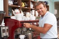 Man Making Coffee In Cafe