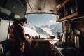 Man making coffee in kitchen camper van with snowy mountain view. Generative ai