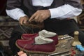 The man making colorful traditional leather shoes carefully. Royalty Free Stock Photo