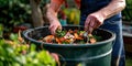 A man is making compost from kitchen leftovers